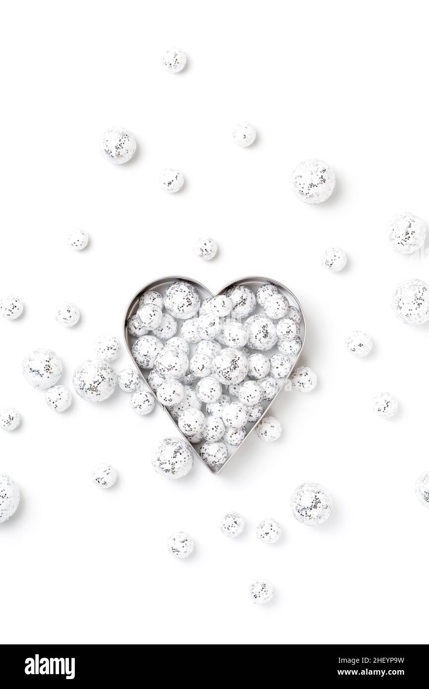 Saint Valentine`s day greeting card,  heart symbol in silver glitter balls on white, minimal festive frame Stock Photo
